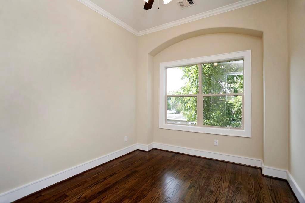 Second bedroom with large arch for unique touch.