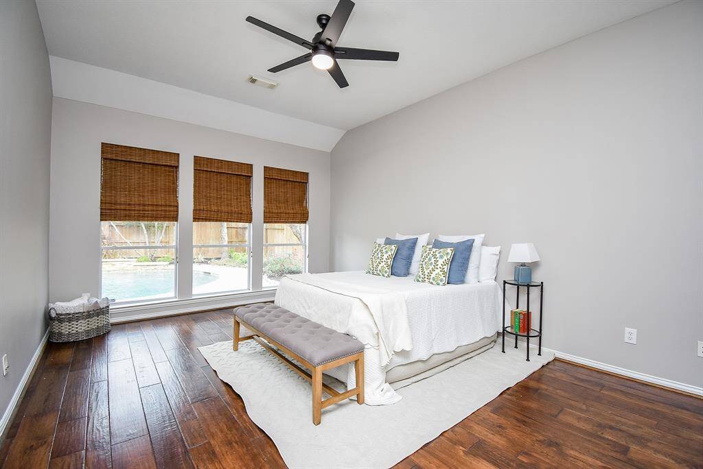 The large windows provide beautiful natural light and offer a peaceful view of the pool and backyard oasis.