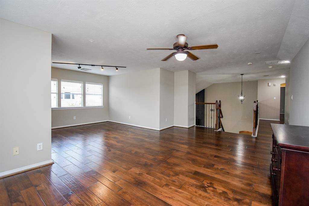 Featuring recessed lighting, a ceiling fan for added comfort, and an open layout, the room is ideal for creating a media space, play area, or home office.