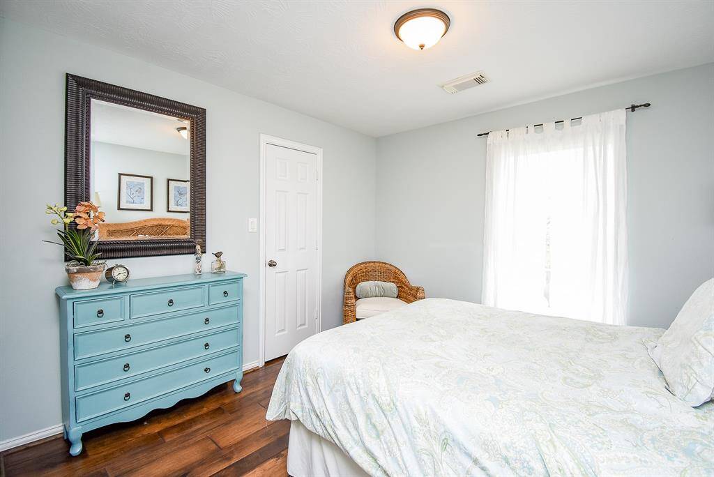Inviting space featuring soft neutral tones, abundant natural light and hardwood flooring.