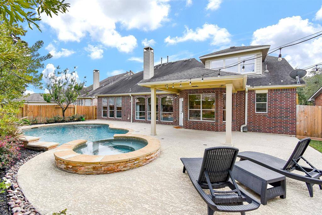 The expansive pool deck offers plenty of room for sun loungers and outdoor dining, creating the perfect setting for summer gatherings.
