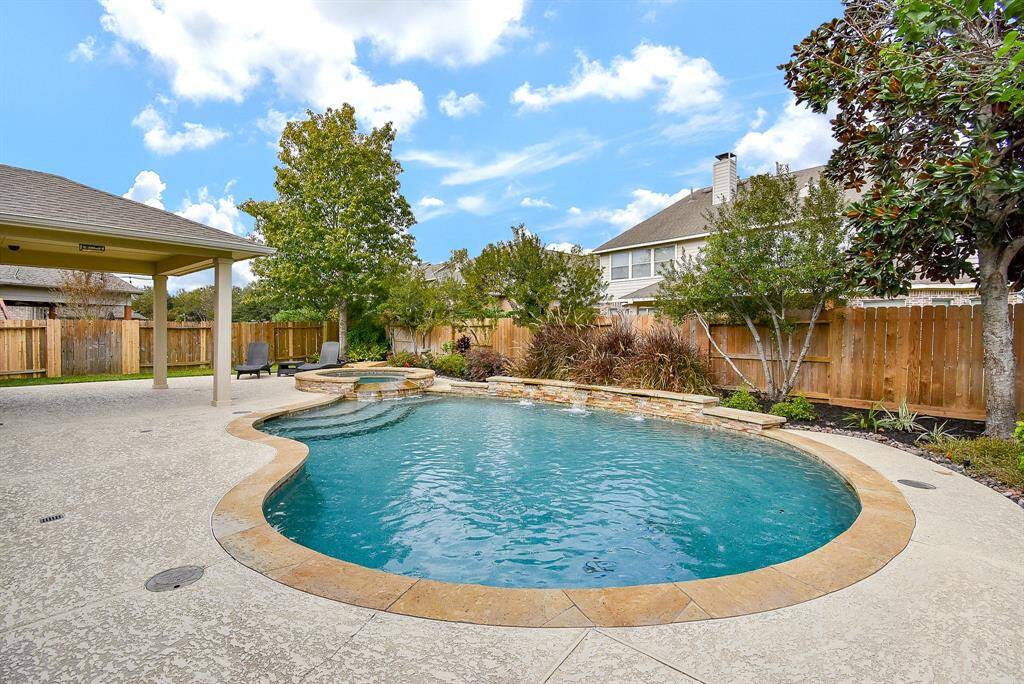 The highlight of the backyard is the sparkling pool with a soothing waterfall feature and integrated spa.