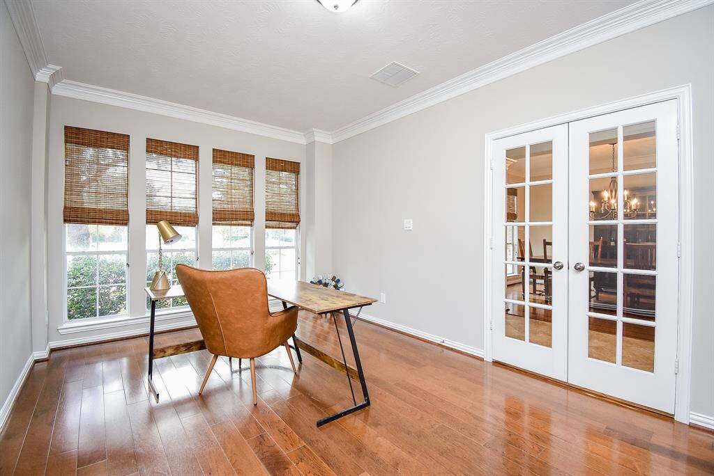 The private office/study is framed by French doors, offering a quiet and versatile space ideal for work or relaxation.