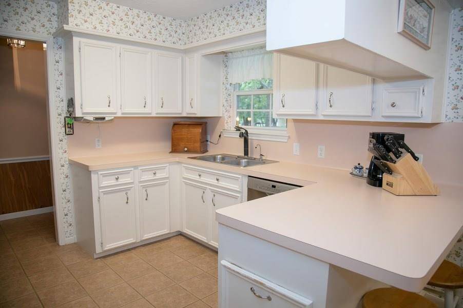 Kitchen on front of home with lots of countertops and storage space.