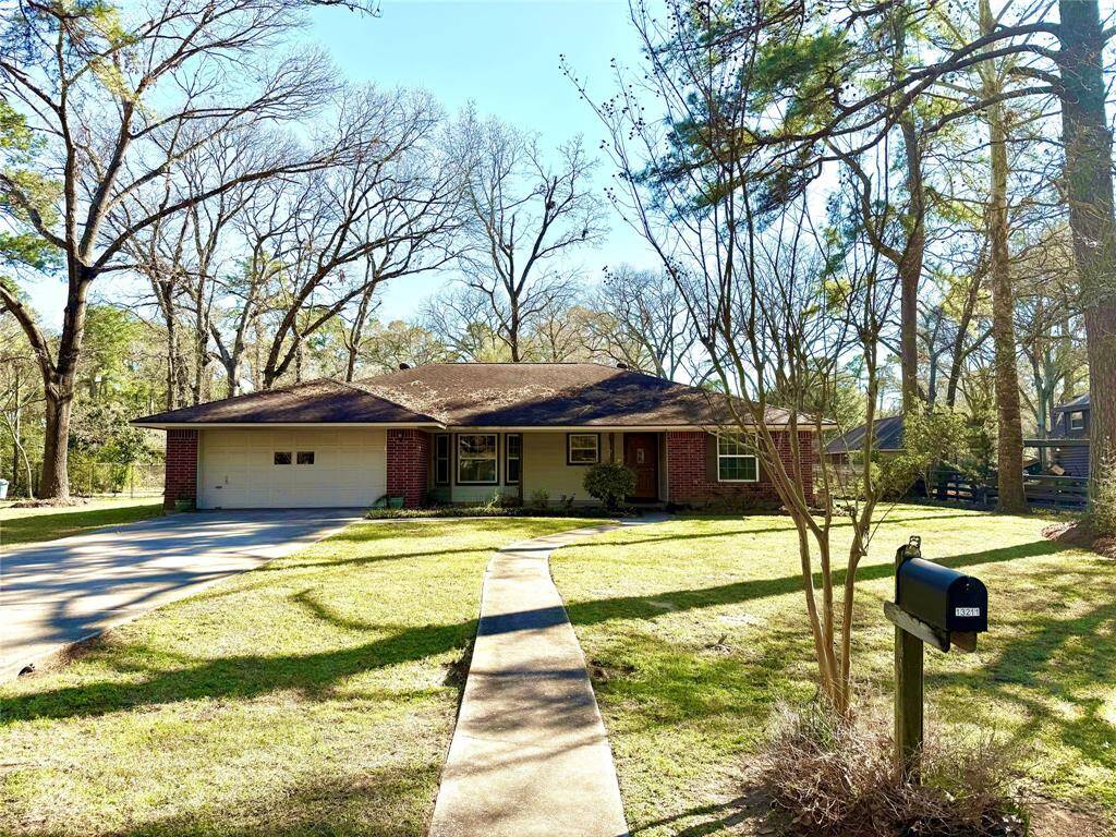 Front of home from street showing entrance and magnificent lot and trees