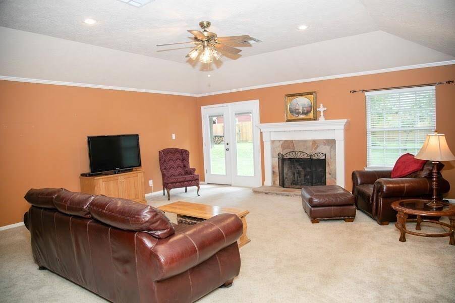 Large family room located on back of home with wood burning fireplace.