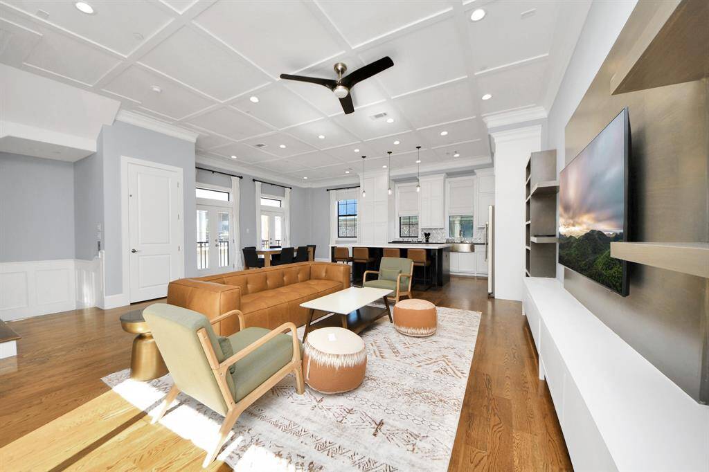 Gather the family and guests together in your lovely living room! Featuring soaring high ceilings, recessed lighting, ceiling fan, custom paint, gorgeous floors, and large windows that provide plenty of natural lighting throughout the day.