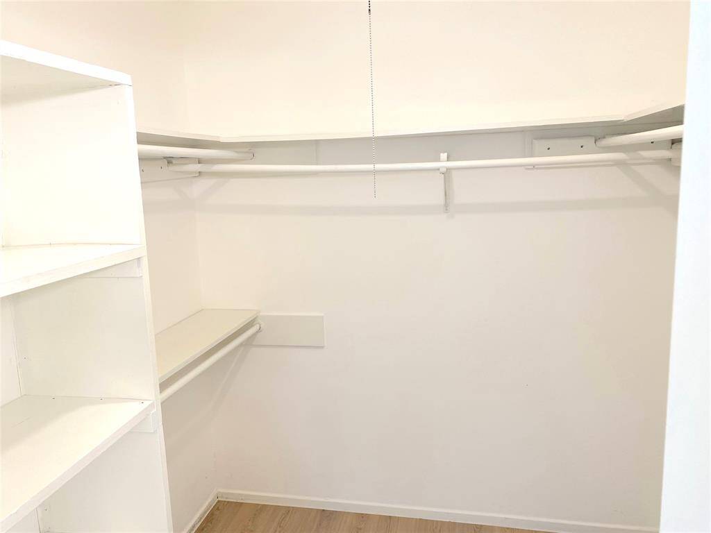 Primary bedroom walk in closet