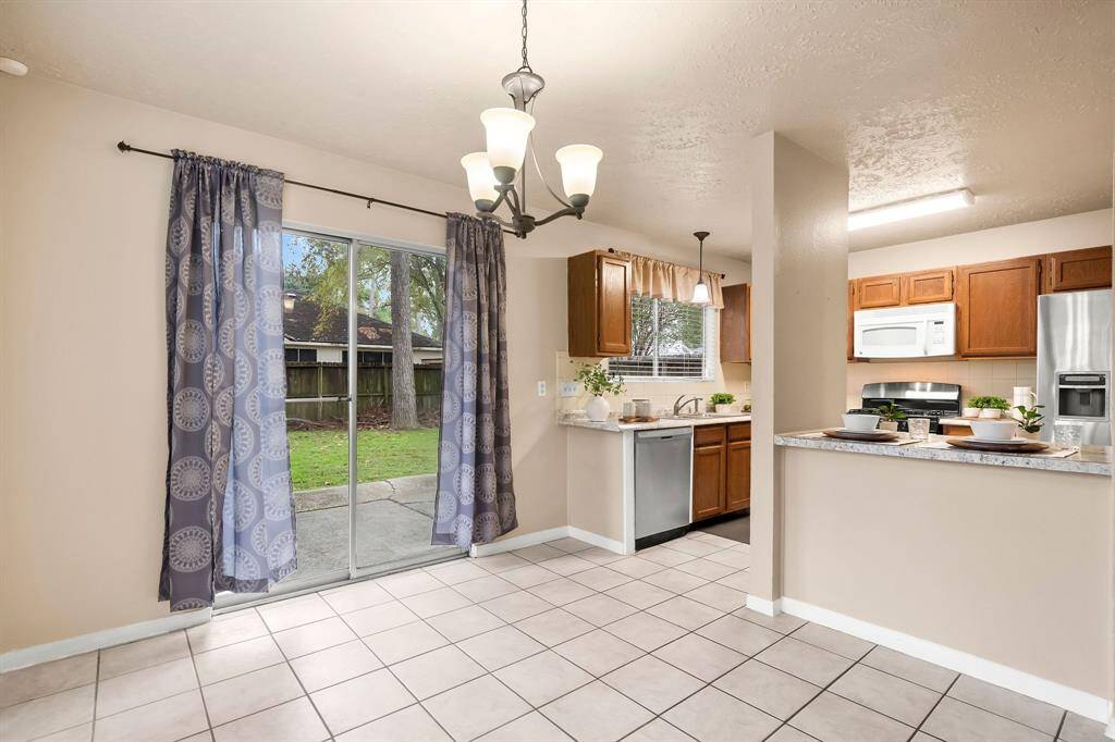 Large sliding doors provide access to backyard and patio