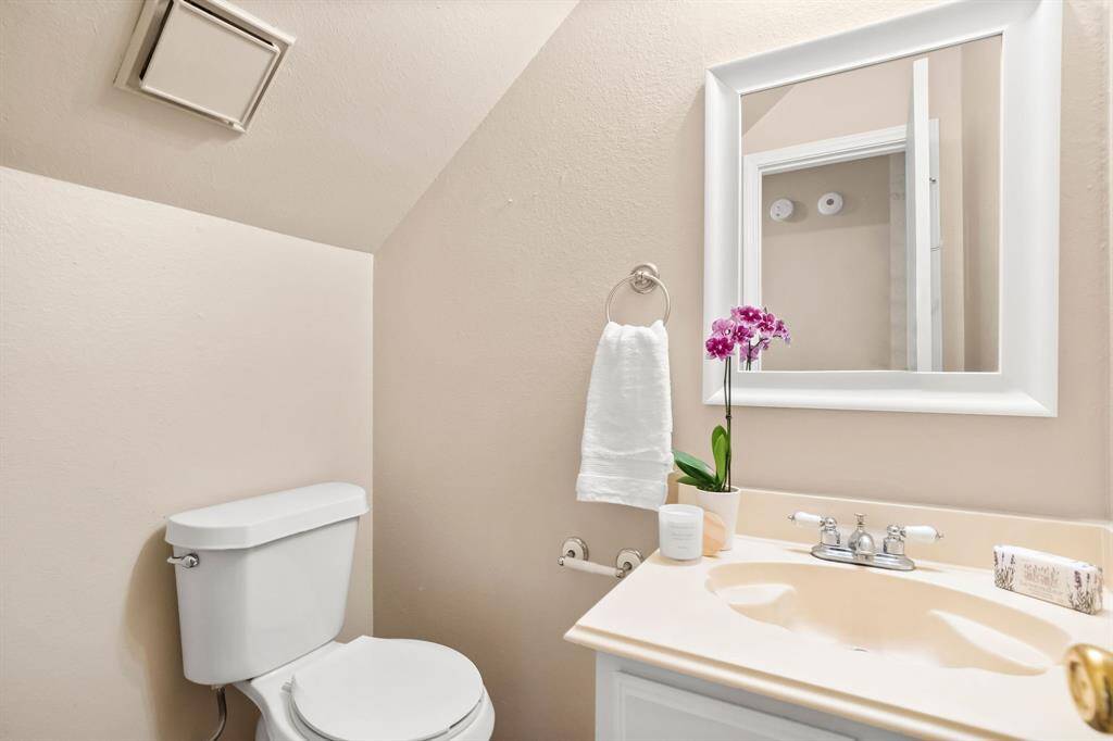 A cute powder bath is tucked under the stairs