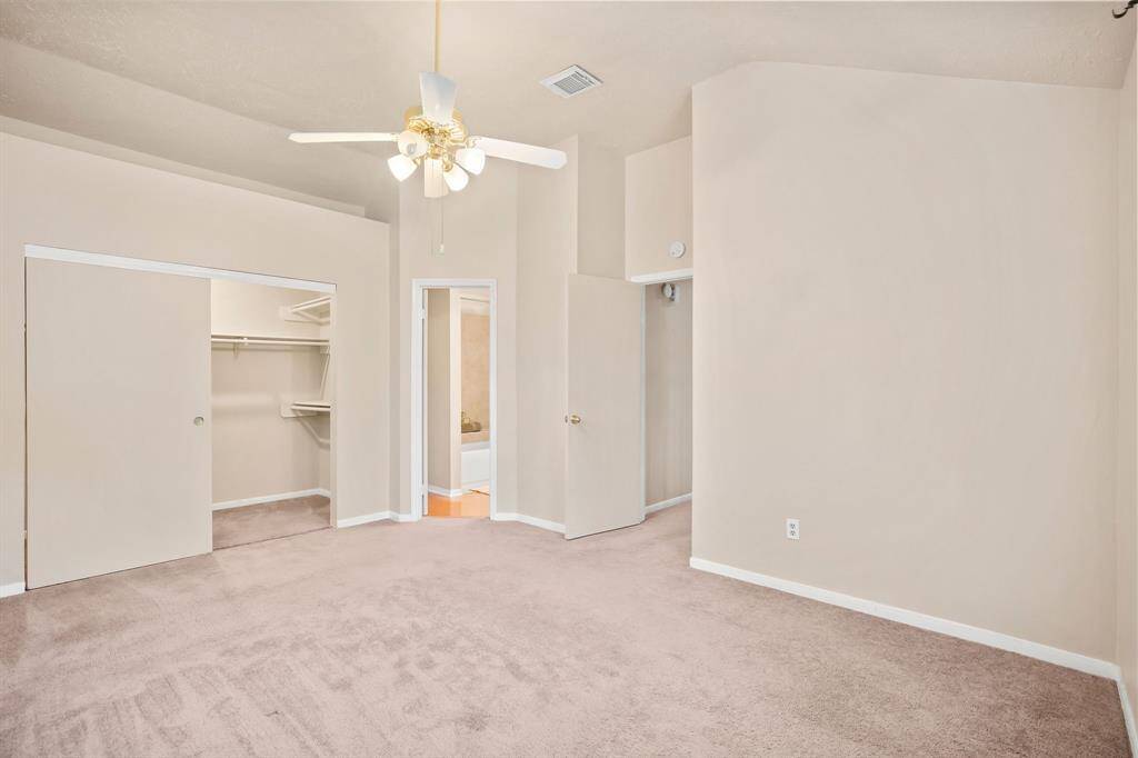 Bedroom also features a ceiling fan and walk-in closet