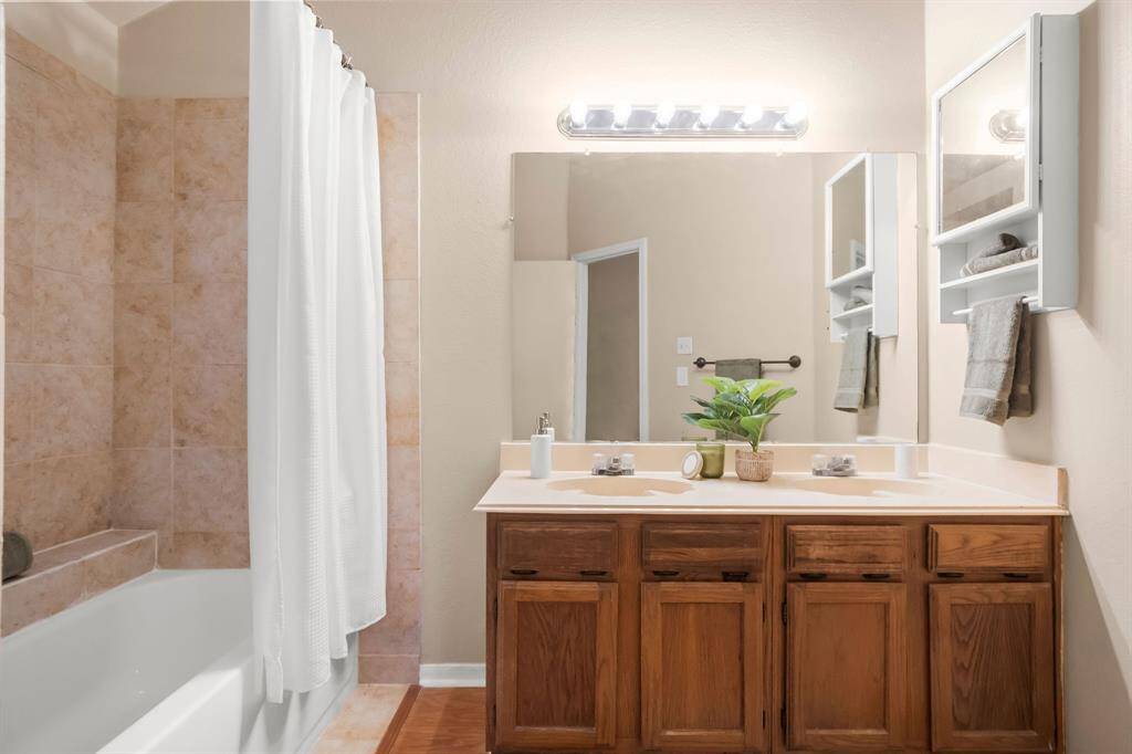 En suite bath features double sinks