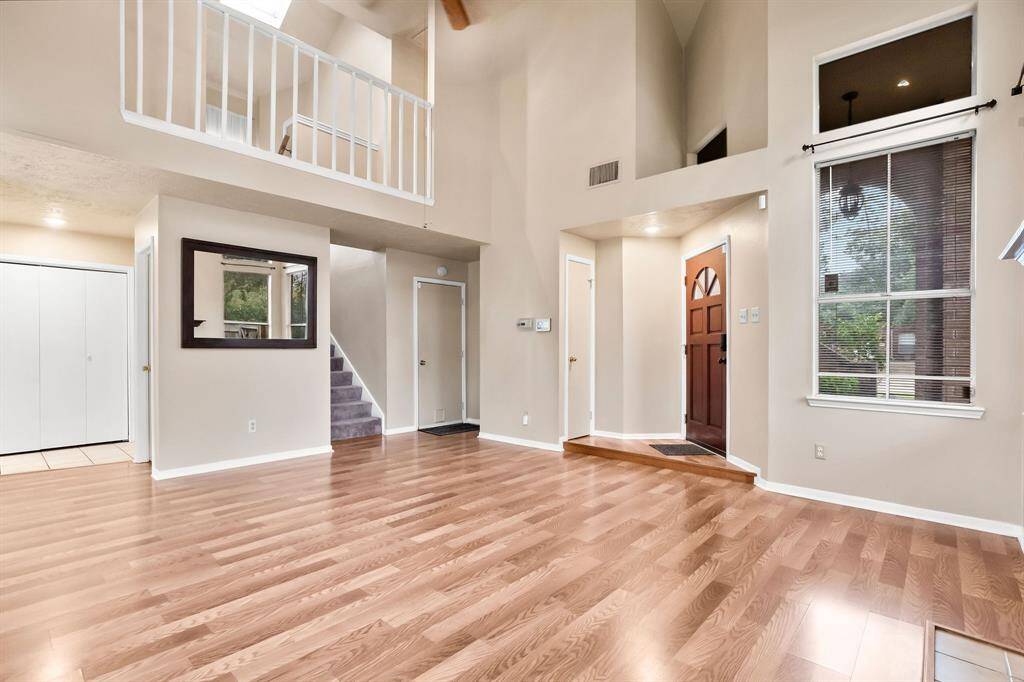 A convenient coat closet and access to the attached garage are located to the left of the doorway