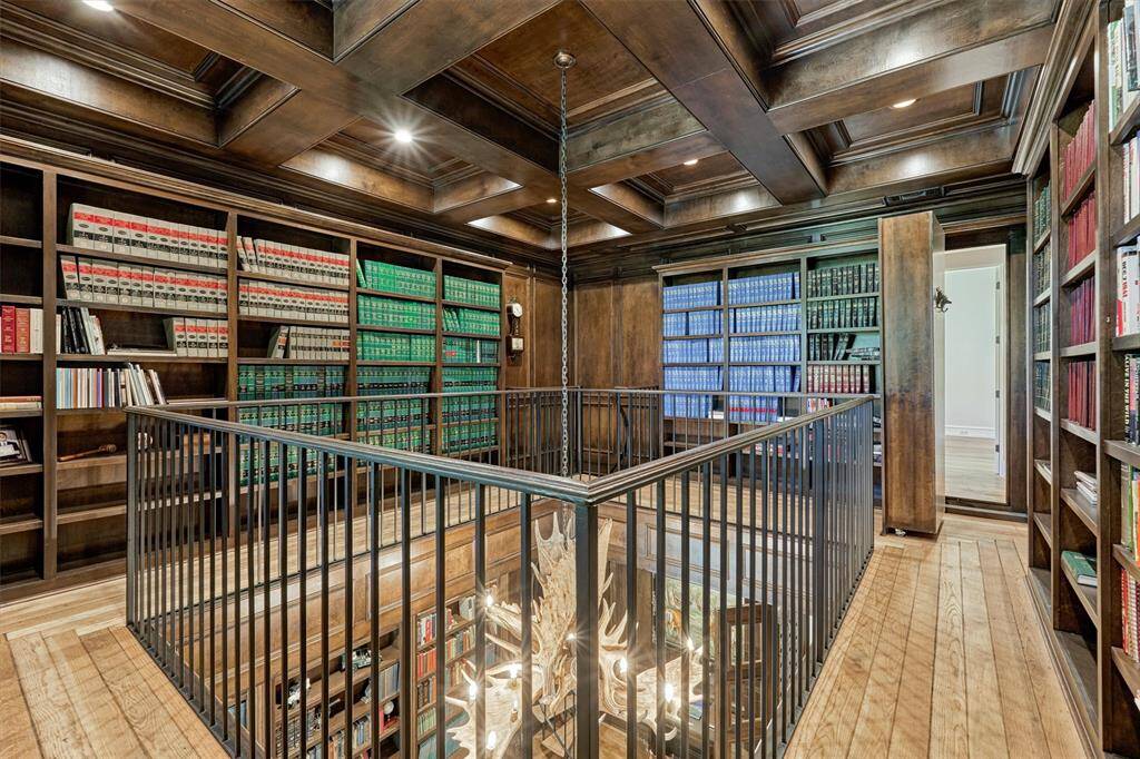 Library houses an extensive collection of books.  Secret passage door shown here while open to upstairs hallway.