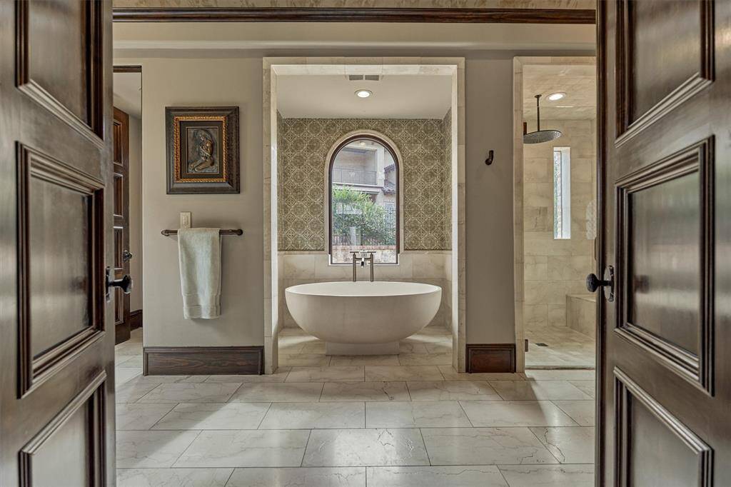 Sumptuous primary bath offers a spa-like escape, with soaking tub, a soothing rain-head shower, and an airy layout designed to bring tranquility to even the busiest days.