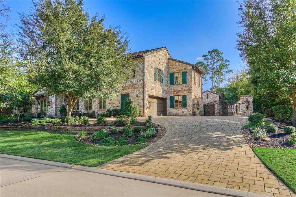 Main house gated motor court leads to garage bay with 8,000-lb. auto lift. There's also an attached two-car garage here, while 2nd house has another motor court and 8 more garage bays.