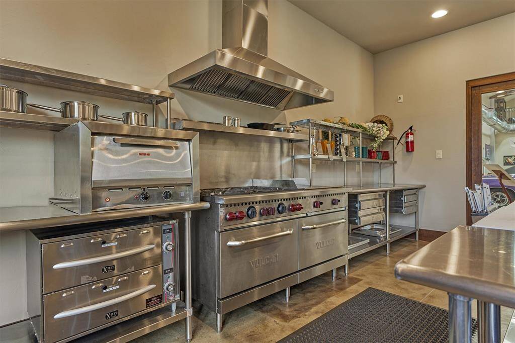 Commercial kitchen featuring top-of-the-line appliances, ample prep space, and professional-grade amenities.