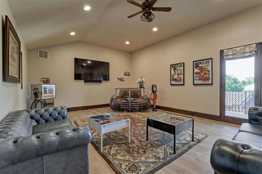 Second-floor family room has  its own balcony, providing a great view of the backyard with  brick raised garden beds of the main house.