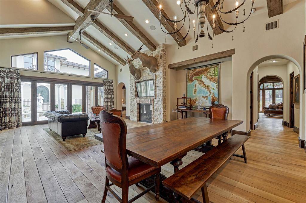 Living room has dramatic wall of windows and glass doors inviting in abundant natural light.