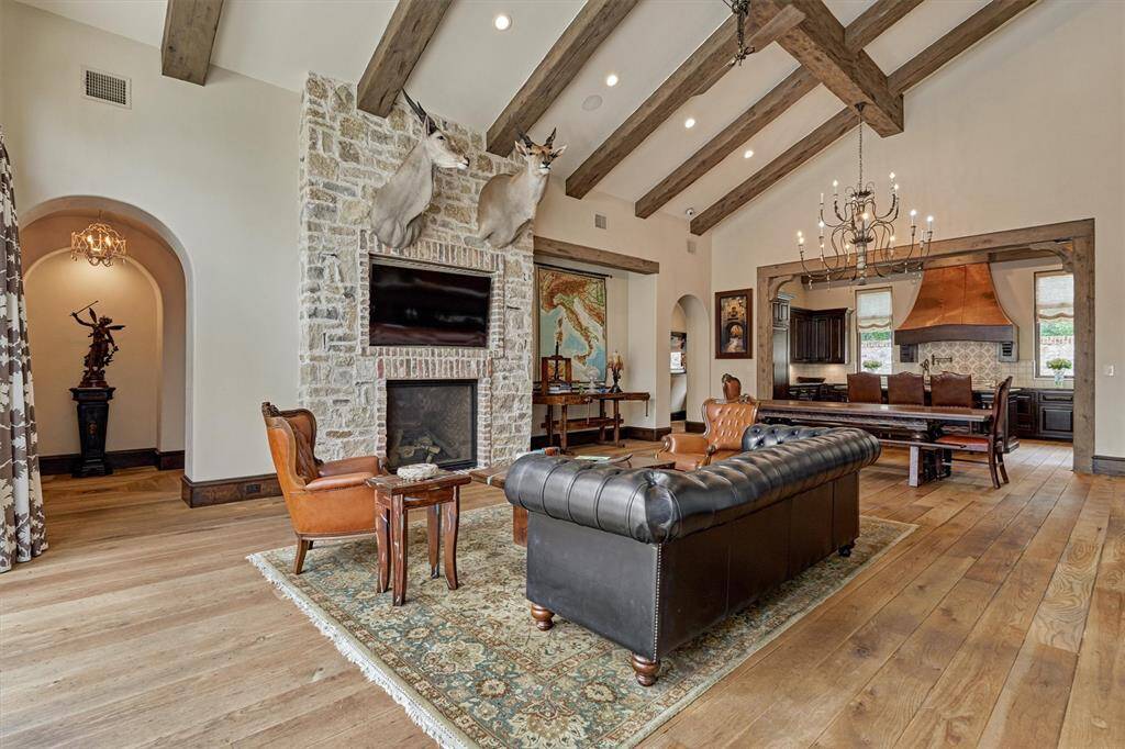 Expansive open-concept living and dining area. Rich ¾-inch solid white oak flooring flows into kitchen, primary bedroom, and family room.