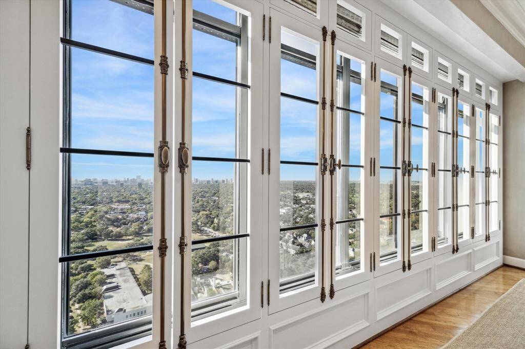 Rows of shutters with classic Cremone bolts add an unexpected detail to the home’s oversized windows.