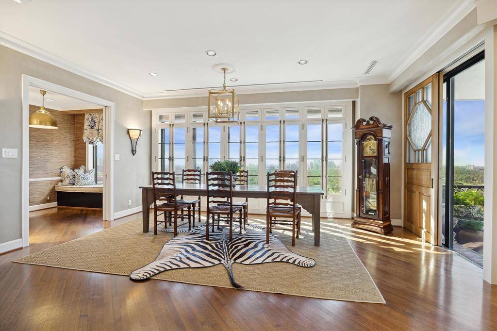 Plan your next dinner party in the elegant dining room, featuring sunset views, terrace access and Maitland Smith Sconces.