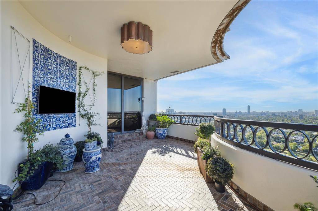 Imagine world-class al fresco entertaining on this gorgeous private terrace trimmed with herringbone tile floors, a Mexican tile mosaic, an outdoor television and irrigated planters.