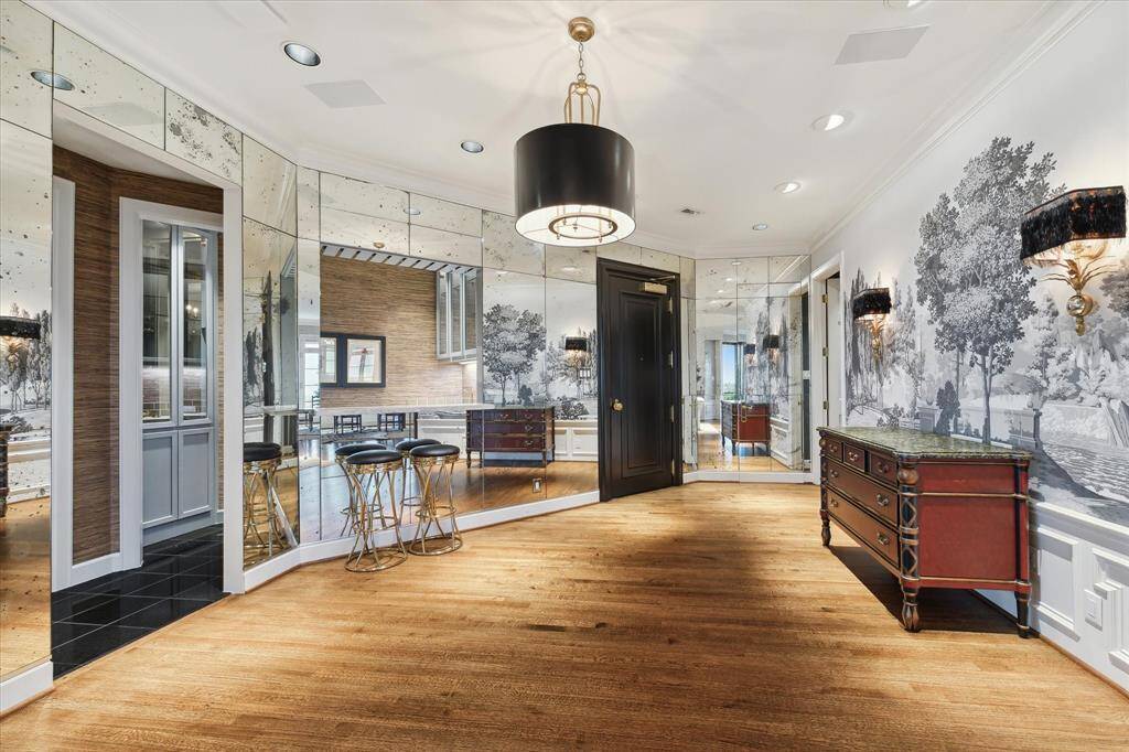Zuber wallcoverings, antiqued mirrors and designer lighting run throughout the gracious foyer.