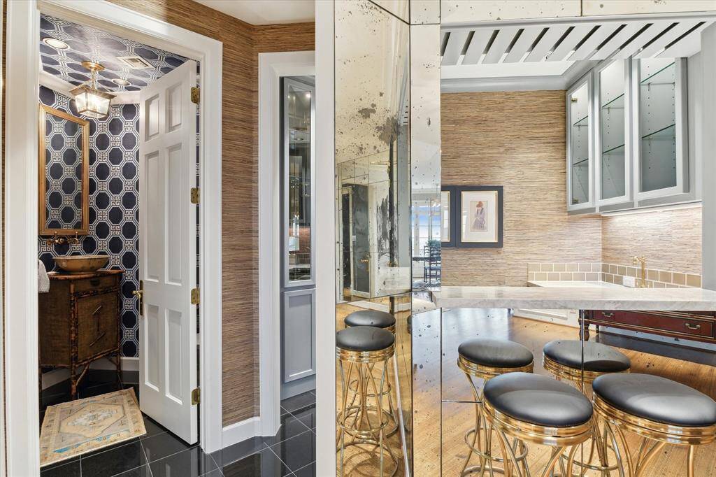 The chic powder room and wet bar add wonderful convenience to the living spaces.