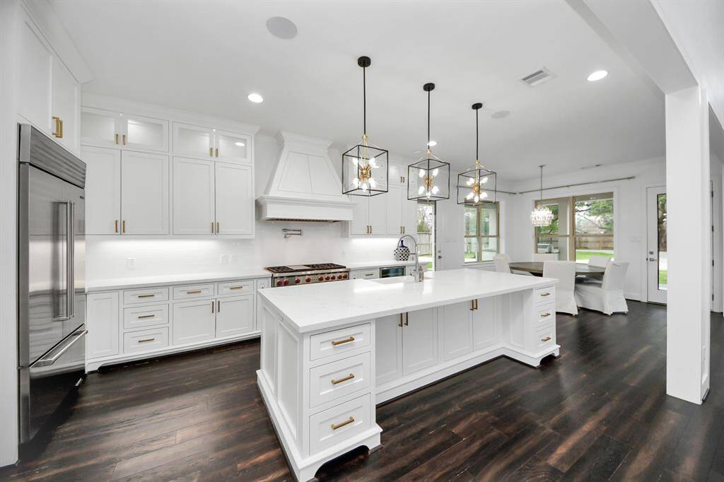 The kitchen is phenomenal! With bespoke cabinetry, quartz countertops, high-end appliances including a Wolf range with pot filler, Sub-Zero refrigerator and so much more, this room does not disappoint!
