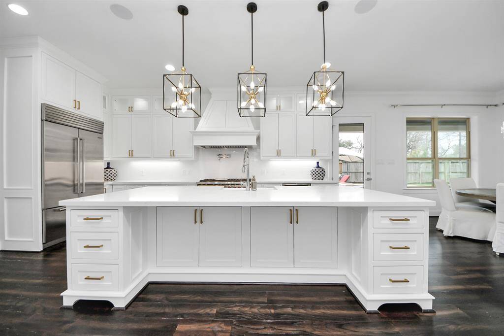 The gorgeous, oversized kitchen island with sink area offers additional storage, countertop and seating space!