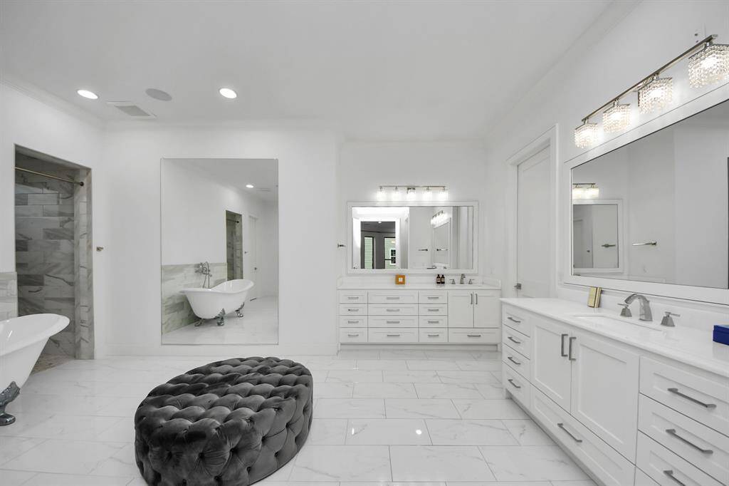An entire room of its own, the primary ensuite bathroom is an incredible 22'7" x 16'3", and features dual vanity areas, an elegant soaking tub, designer lighting, quartz countertops and marble flooring!