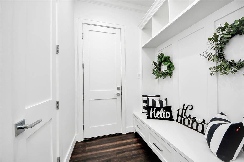 Also downstairs, you'll find this cozy nook area off the garage and main entry which provides seating and extra storage!