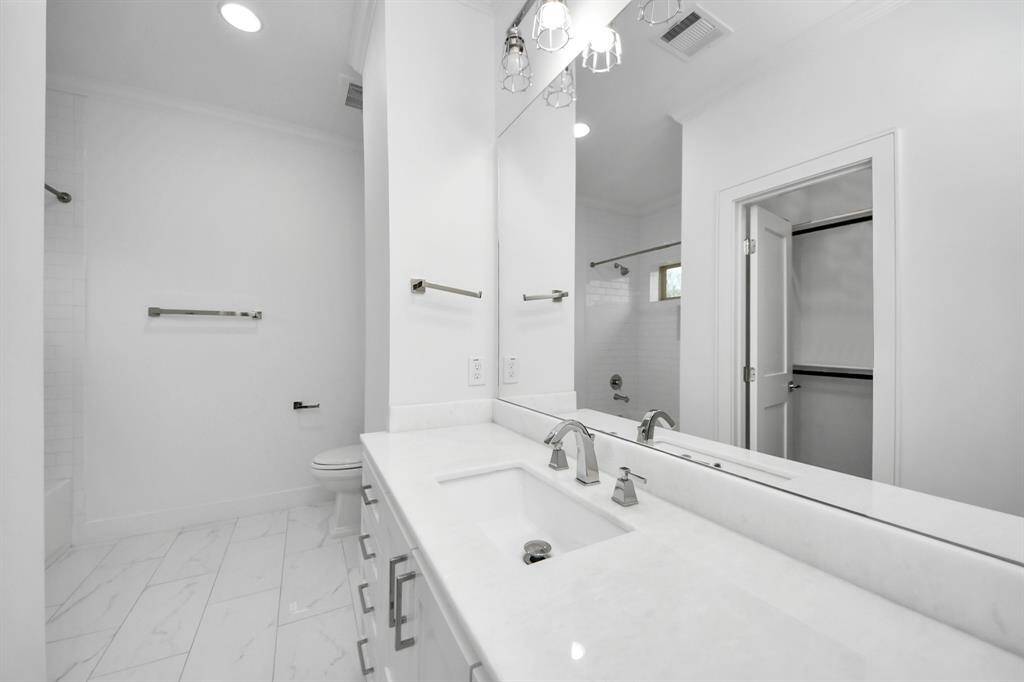 The second ensuite bath upstairs is also spacious and well-appointed with quartz countertops, marble flooring and a walk-in closet!