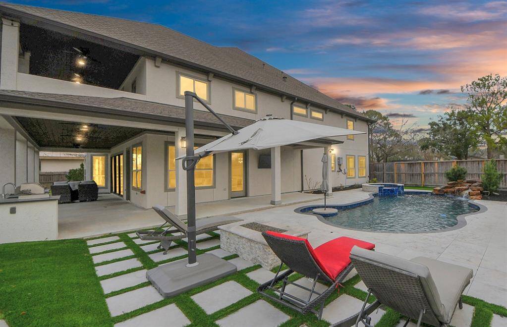 The sparkling heated pool with spa and waterfall feature is 6' deep and boasts a sit-in table with umbrella in the shallow corner, and the seating area shown here features a gas fire pit for warmth and ambiance!
