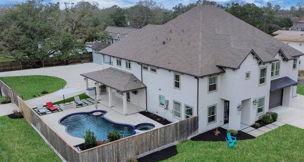 Shown here is a lovely overview of this custom estate on a half-acre lot - the curved driveway which services the rear property is accessible from two automatic gates!
