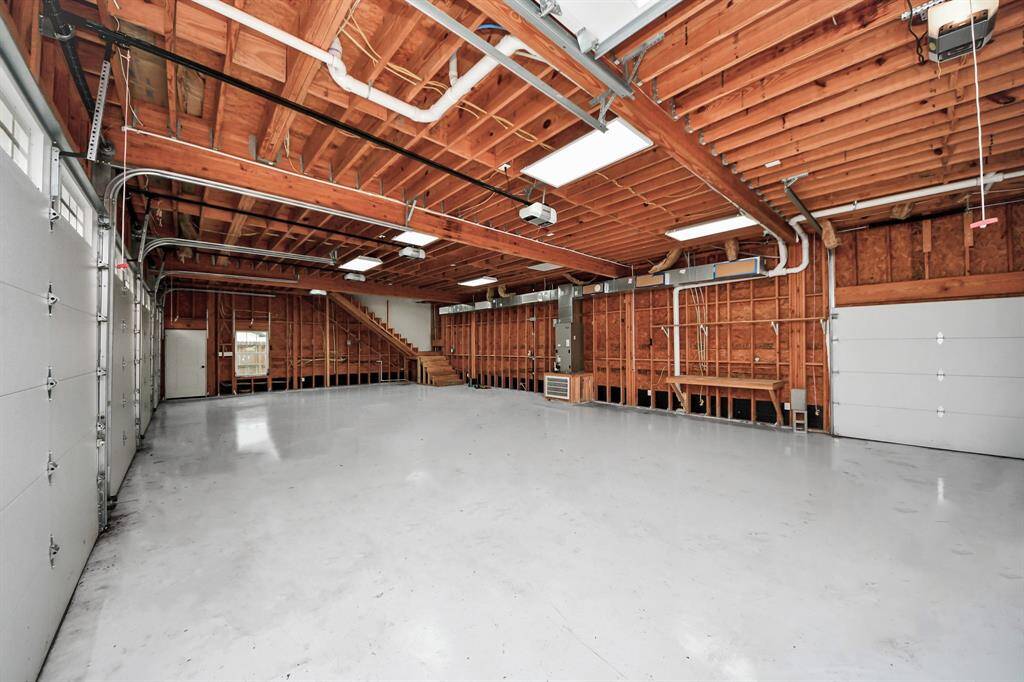 The 54'6" x 29' 8" garage beneath the apartment is fully air-conditioned, offers 9' doors and an 11' ceiling, and also includes a rear garage door!