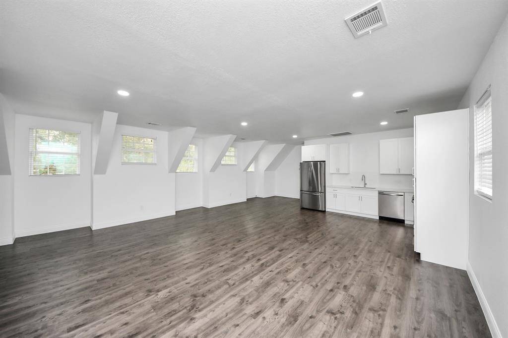 This view of the garage apartment living space highlights the many charming window details which bathe the space in light!