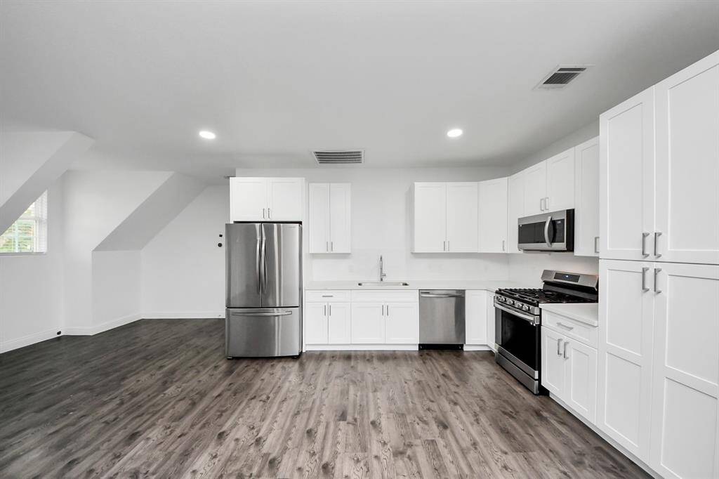 This closeup of the kitchen shows the sleek stainless steel appliances and ample cabinetry - and there is plenty of space for a kitchen island!