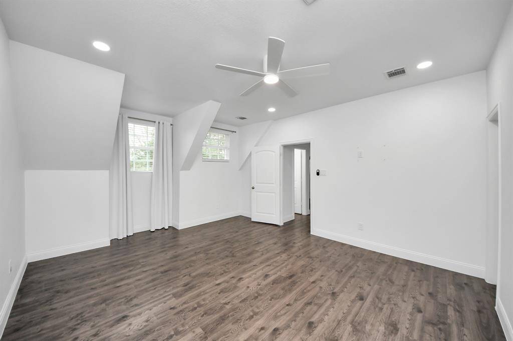 The primary bedroom in the garage apartment is lovely and bright, and features its own ensuite bathroom and walk-in closet!