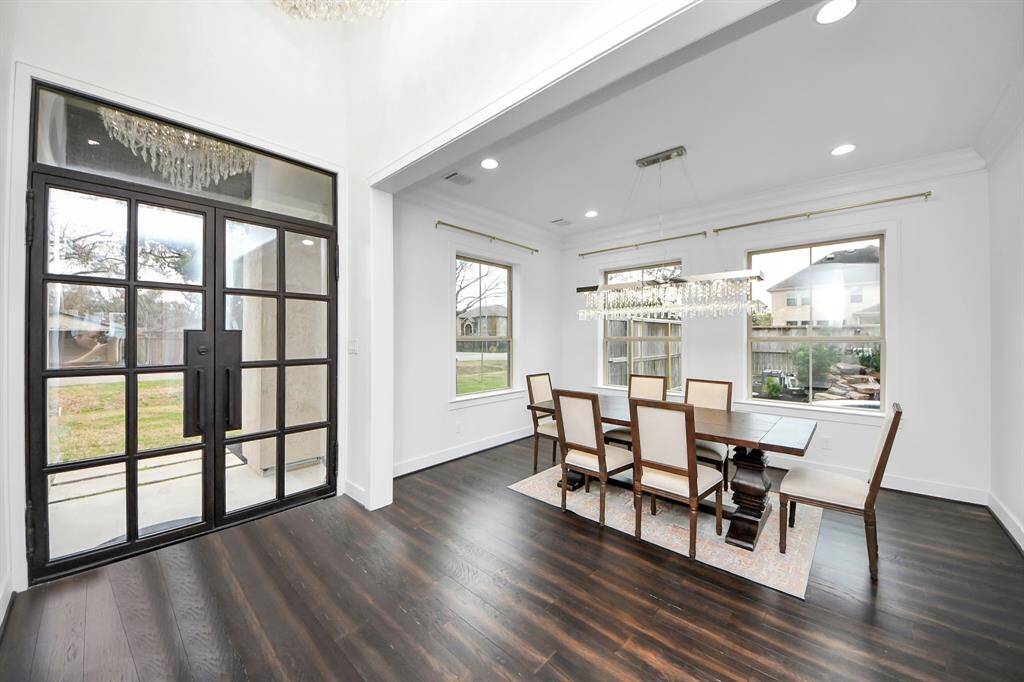 Elegant, modern double steel entry doors and an exquisite chandelier welcome you into the main home and the beautiful 14'4" x 11'7" dining area to the left!