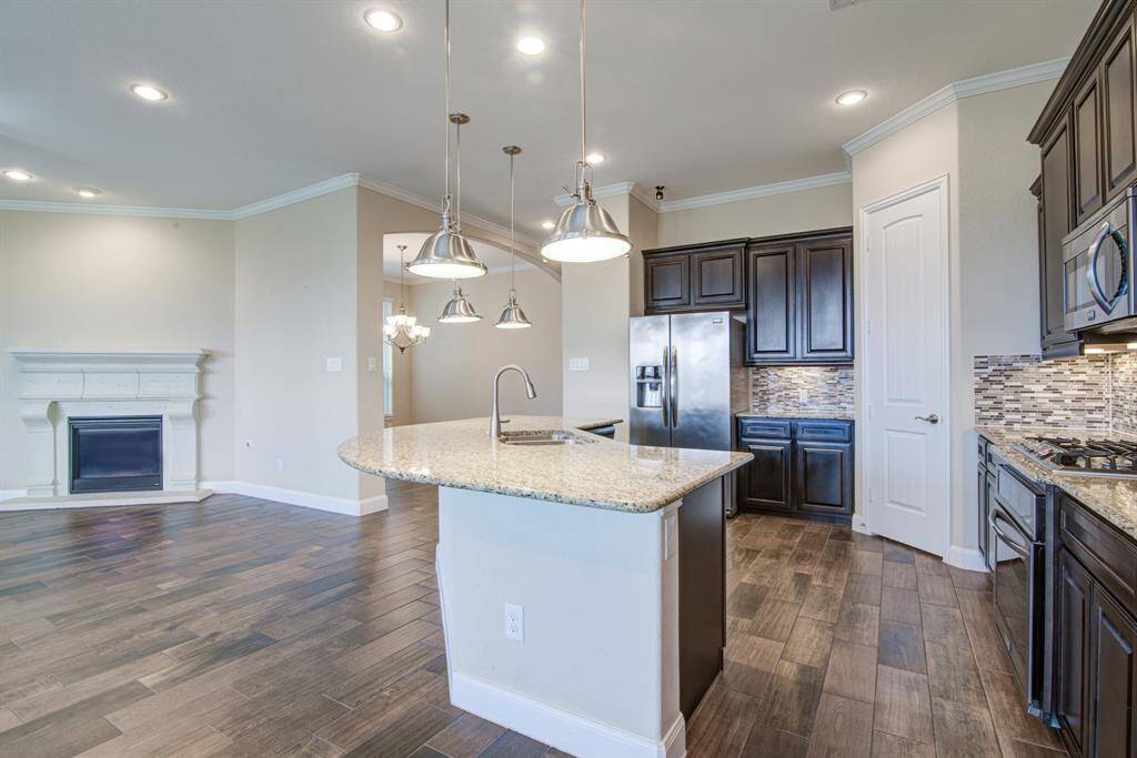 The granite countertops and tile backsplash are both beautiful and functional.