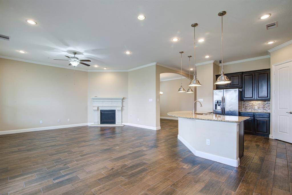 The living room features a corner fireplace with gas logs and a large mantle.
