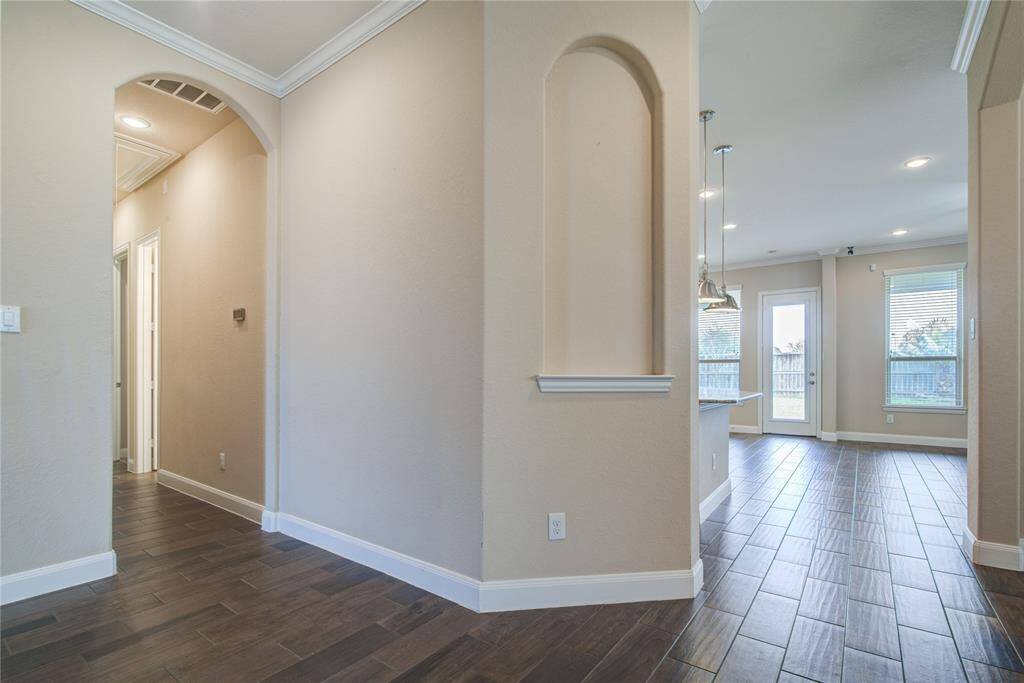 The hallway to the left as you enter the home leads to the secondary bedrooms and bathroom in the main part of the house.