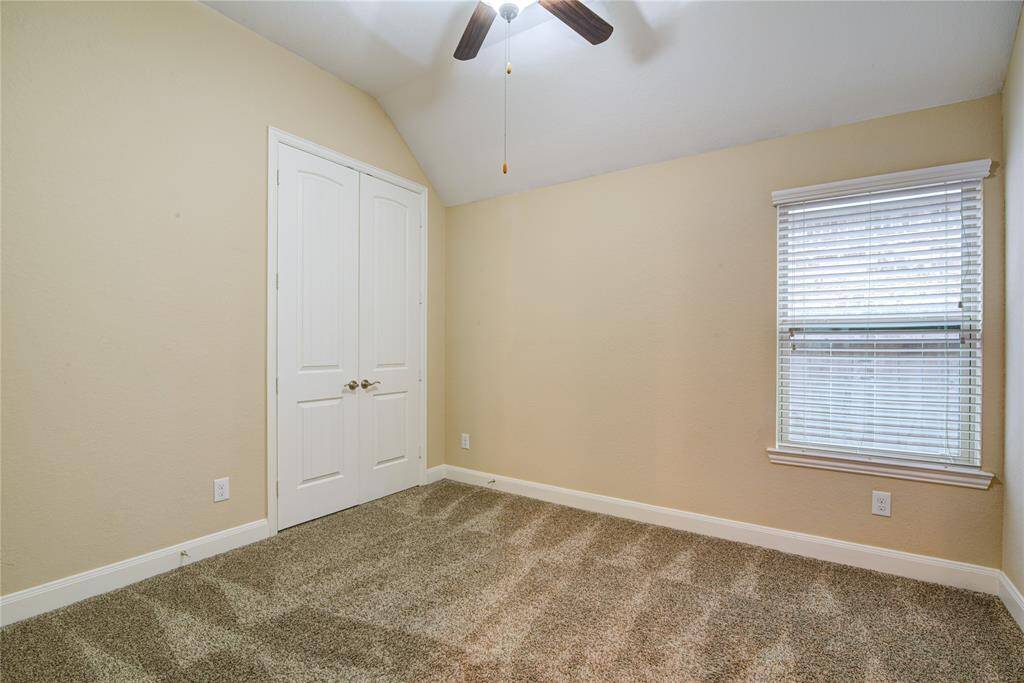 Bedroom 3 also has tall ceilings and a fan with light fixture.