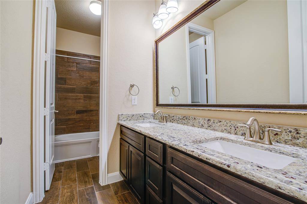 Bathroom 2 is on the hallway with the secondary bedrooms. It features double sinks and separate area with the commode and tub/shower combination.