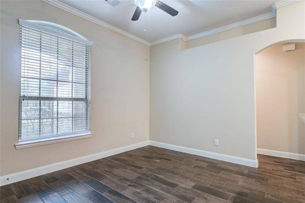 The living room overlooks the front porch and features the same wood-look tile that is found in the main house.