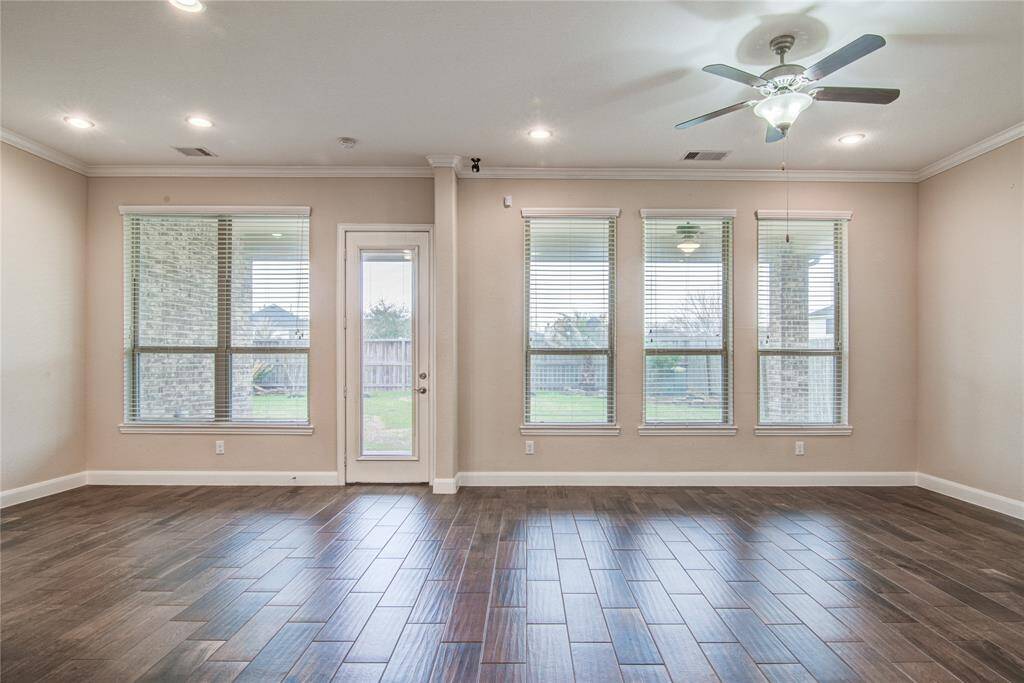 Back in the main house, the wall of windows across the breakfast room and living room look out onto the large covered back patio.