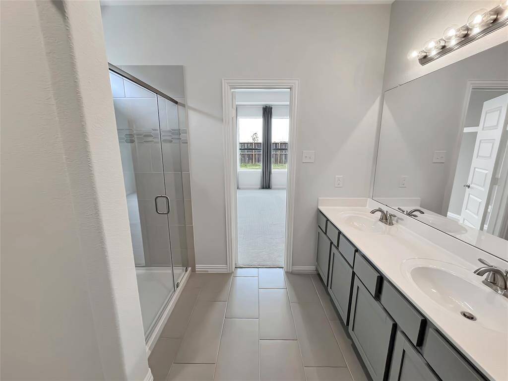 The Robin- Primary Bathroom with Dual Vanity and Walk-in Shower.