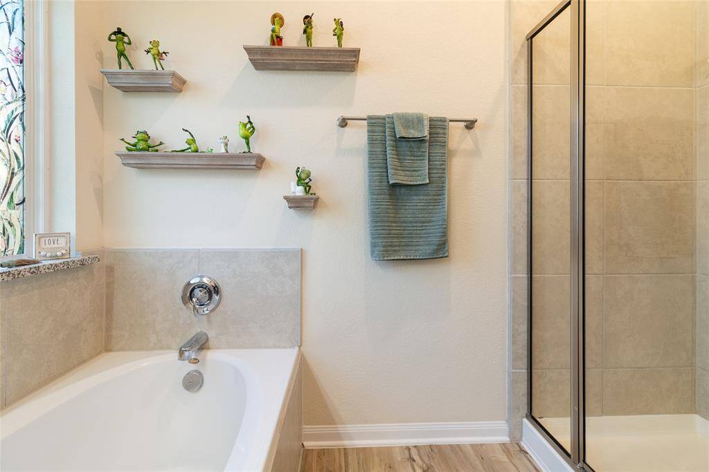 Unwind in the luxurious soaking tub or enjoy a rejuvenating shower offering both relaxation & flexibility in your primary bathroom retreat.